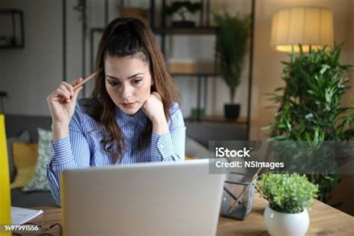 Woman analyzing documents while sitting at home